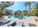 Beautiful community pool with rock waterfall feature and ample seating with lounge chairs at 4200 S Valley View Blvd # 3078, Las Vegas, NV 89103