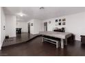Inviting living area featuring hardwood floors, a game table, and views into the dining room at 4509 Paseo Del Ray Dr, Las Vegas, NV 89121