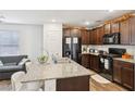 Well-equipped kitchen featuring granite countertops, a center island, and a view to the living area at 4612 Townwall St, Las Vegas, NV 89115