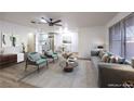 Open-concept living room with modern decor, light wood floors, and ample natural light at 5101 Village Dr, Las Vegas, NV 89142