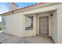Close-up of the front entrance with a security door, small window, and outdoor light fixture at 5762 Yerington Ave, Las Vegas, NV 89110