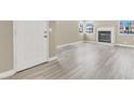 Bright living room featuring stylish gray wood flooring and fireplace at 5762 Yerington Ave, Las Vegas, NV 89110
