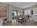 Cozy dining area with a stylish table setting, sliding glass doors, and elegant decor at 6325 Gambetta St, Las Vegas, NV 89115