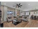 Inviting living room with plush sofas, a ceiling fan, and ample natural light, perfect for relaxation at 6325 Gambetta St, Las Vegas, NV 89115