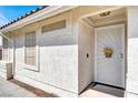 Inviting front entrance with decorative security door, textured wall, and covered porch at 656 Thornewood Pl, Las Vegas, NV 89123