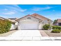 Charming single-story home with a classic garage door, red tile roof, and desert landscaping at 656 Thornewood Pl, Las Vegas, NV 89123
