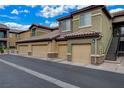 View of condominiums with attached garages and stairs to upper units at 6868 Sky Pointe Dr # 1089, Las Vegas, NV 89131