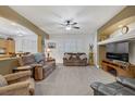 Spacious living room featuring neutral paint, carpet, ceiling fan, and comfortable furniture at 7013 Bisoni St, Las Vegas, NV 89149