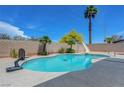 Beautiful backyard pool with slide, basketball hoop and a tall palm tree at 7726 Keating Cir, Las Vegas, NV 89147