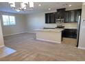Modern kitchen with granite countertops, stainless steel appliances, and dark cabinetry at 806 Star Estates Ave, North Las Vegas, NV 89086