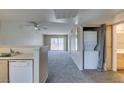 Cozy living area with a ceiling fan, washer, dryer, and access to a balcony at 8070 W Russell Rd # 2121, Las Vegas, NV 89113