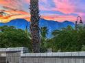 Beautiful mountain views with desert landscaping elements of bushes and cactus with a blue and pink sunset at 8134 Maddingley Ave, Las Vegas, NV 89117