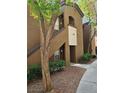 Exterior elevation of a two-story condo with tasteful landscaping in a well-maintained community at 9000 Las Vegas Blvd # 2033, Las Vegas, NV 89123