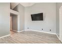 Spacious bedroom featuring modern light-gray walls and white wood-look flooring at 901 Clipper Dr, Henderson, NV 89015