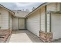 Neutral home featuring rock accents, a modern front door, and a one-car garage at 901 Clipper Dr, Henderson, NV 89015
