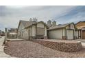 Side view of home showing the yard, neutral siding, and the attached garage at 901 Clipper Dr, Henderson, NV 89015