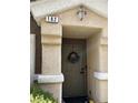 A close up of the house's front door with plants and a decorative wreath at 9133 Forest Willow Ave # 102, Las Vegas, NV 89149