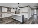 Modern kitchen with white cabinets, quartz countertops, and stainless steel appliances at 9638 Smiley Creek St, Las Vegas, NV 89178