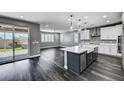 Open-concept kitchen and living area with wood floors and backyard access at 9638 Smiley Creek St, Las Vegas, NV 89178