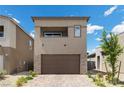 Two-story house featuring neutral tone stucco, brick accents, a two car garage, and well-maintained landscaping at 9715 Harper Edge St, Las Vegas, NV 89143