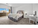 Bright main bedroom with a walk out balcony and a vanity area for getting ready at 9715 Harper Edge St, Las Vegas, NV 89143