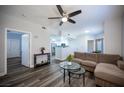 Bright living room with contemporary decor, modern ceiling fan, and seamless flow to the kitchen at 10245 S Maryland Pkwy # 106, Las Vegas, NV 89183