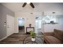 Cozy living room showcasing an open layout, recessed lighting, and views into the bedroom and kitchen at 10245 S Maryland Pkwy # 106, Las Vegas, NV 89183