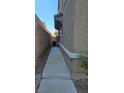 Narrow side yard of home with walkway at 1050 Spotted Saddle St, Henderson, NV 89015