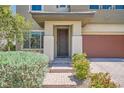 Inviting front entrance with brick steps, desert landscaping, and a covered porch at 10693 Harvest Green Way, Las Vegas, NV 89135