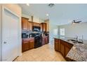 View of kitchen with stainless steel appliances, granite countertops, and tile flooring at 10693 Harvest Green Way, Las Vegas, NV 89135