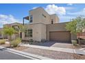 Contemporary home featuring stone accents, a two-car garage, desert landscaping, and a brick driveway at 10895 Artesano Ave, Las Vegas, NV 89135