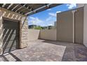 Private patio featuring stone accents, brick flooring, and an enclosed wall providing outdoor space at 10895 Artesano Ave, Las Vegas, NV 89135