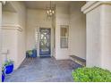 Covered front porch with tile flooring, decorative door, and seating at 11 Feather Sound Dr, Henderson, NV 89052