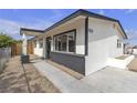 Inviting home exterior with a covered porch, contrasting trim, and desert landscaping at 1424 Balzar Ave, Las Vegas, NV 89106