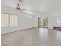 Spacious living room with tile flooring, a ceiling fan, and natural light at 1846 High Mesa Dr, Henderson, NV 89012