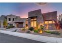 Contemporary home showcasing stone facade, modern design, manicured landscaping, and stylish garage door at 2180 Skyline Heights Ln, Henderson, NV 89052