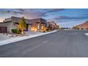 A modern luxury home neighborhood with wide streets, beautiful landscaping, and mountain views at 2180 Skyline Heights Ln, Henderson, NV 89052