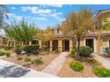 Inviting townhome with well-manicured landscaping, covered entrance, and a welcoming facade at 3088 Bicentennial Pkwy, Henderson, NV 89044