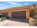 Attached two-car garage with brick-paved driveway and well-maintained exterior at 3088 Bicentennial Pkwy, Henderson, NV 89044