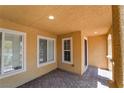 Charming covered porch with brick flooring, providing a welcoming entry and a shaded outdoor space at 3088 Bicentennial Pkwy, Henderson, NV 89044