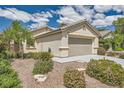 Inviting single-story home with a well-maintained lawn, desert landscaping, and an attached two-car garage at 3257 River Glorious Ln, Las Vegas, NV 89135