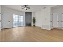 Living room featuring wood floors, modern fireplace, and access to balcony at 3318 N Decatur Blvd # 1043, Las Vegas, NV 89130