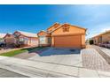 Charming, two-story home features a spacious two-car garage and inviting front yard with vibrant landscaping at 3432 Beca Faith Dr, North Las Vegas, NV 89032