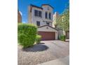 Attractive stucco home showing the driveway leading to the 2-car garage, and manicured landscaping at 345 Gracious Way, Henderson, NV 89011