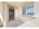 Cozy covered balcony features neutral stucco walls, views of the neighborhood, and an open doorway at 3532 Carisbrook Dr, North Las Vegas, NV 89081