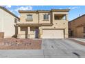 Home's exterior with desert landscaping, covered porch, and a two-car garage; a blend of comfort and style at 3532 Carisbrook Dr, North Las Vegas, NV 89081