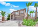 Inviting two-story home with desert landscaping, palm trees, and covered entryway at 3592 N Campbell Rd, Las Vegas, NV 89129