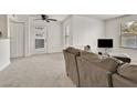 Bright and airy living room with plush carpeting, ceiling fan, and sliding glass door at 5055 W Hacienda Ave # 1136, Las Vegas, NV 89118