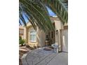 Inviting front entrance with tiled walkway, desert landscaping, and stylish exterior decor at the home's entrance at 5305 Bright Sun Ct, Las Vegas, NV 89130