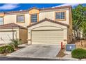 Inviting townhome with an attached garage, showcasing a well-kept facade at 5330 E Charleston Blvd # 28, Las Vegas, NV 89142